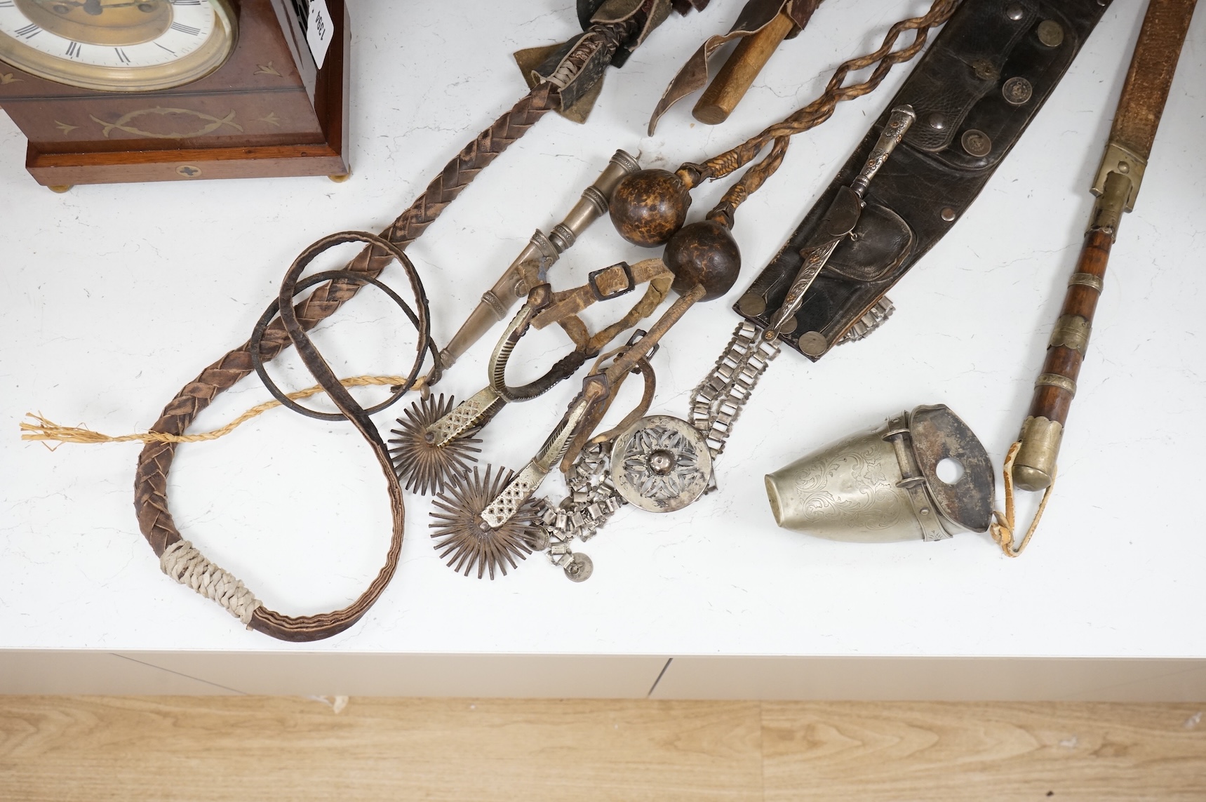 A group of Argentinian Gaucho spurs, bolas, bull whip, daggers and hanger, Longest 100cm